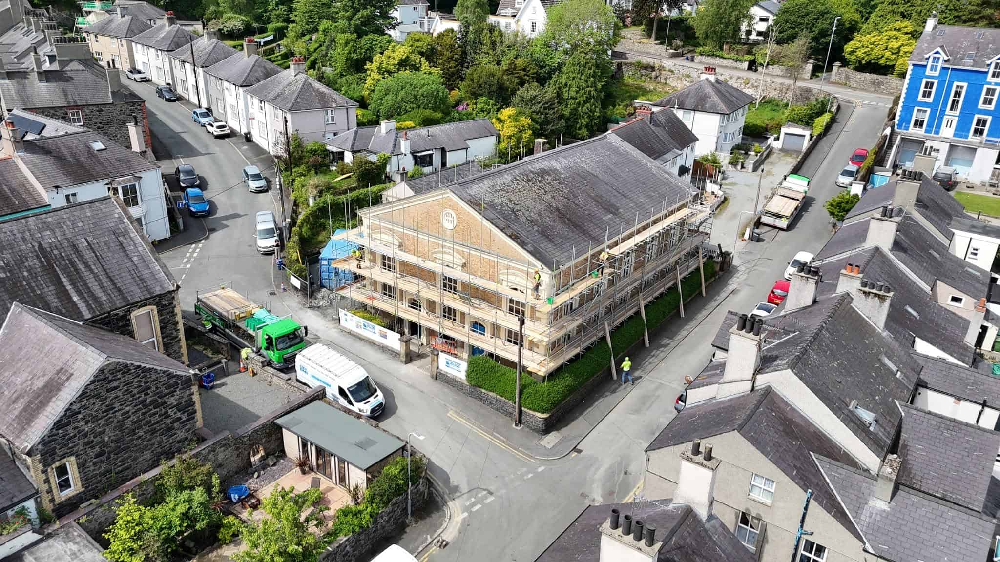 Aerial view of scaffolding around a stone building on a street in North Wales