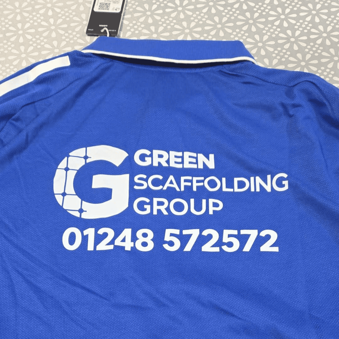 Back of a blue Amlwch Town FC top featuring the Green Scaffolding Group sponsor logo